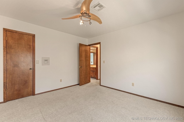 spare room featuring visible vents, ceiling fan, light carpet, and baseboards