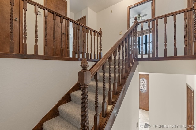 stairway with a ceiling fan