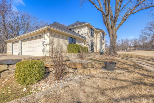 view of home's exterior with driveway and an attached garage