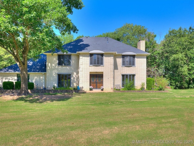 8934 S 41st W Ave, Tulsa, OK 74132 - view of front of house featuring a chimney, a front lawn, and brick siding