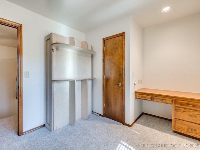 8934 S 41st W Ave, Tulsa, OK 74132 - unfurnished bedroom featuring light colored carpet, built in desk, and recessed lighting