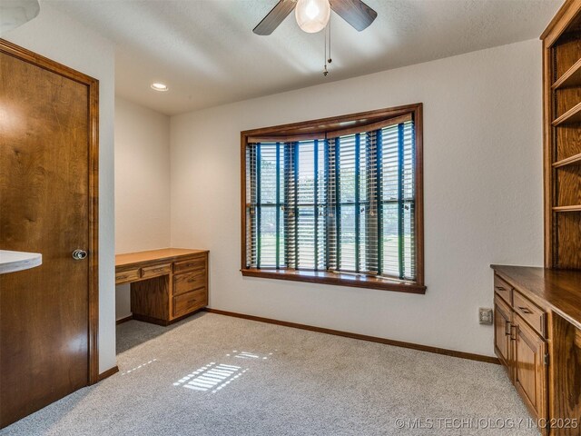 8934 S 41st W Ave, Tulsa, OK 74132 - unfurnished bedroom featuring light colored carpet, built in study area, and a ceiling fan