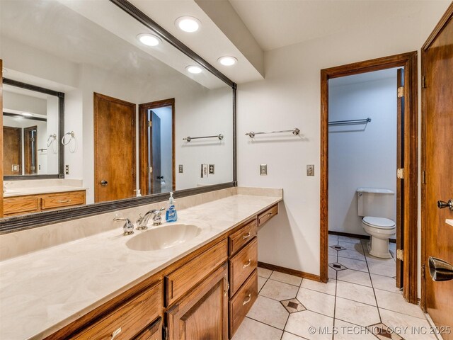 8934 S 41st W Ave, Tulsa, OK 74132 - bathroom with vanity, tile patterned floors, and recessed lighting
