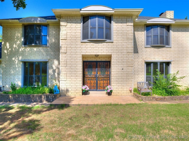 8934 S 41st W Ave, Tulsa, OK 74132 - rear view of house with a yard and brick siding