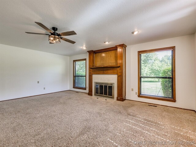 8934 S 41st W Ave, Tulsa, OK 74132 - unfurnished living room with plenty of natural light, a large fireplace, and light colored carpet