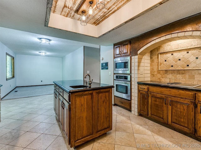 8934 S 41st W Ave, Tulsa, OK 74132 - kitchen with stainless steel appliances, dark countertops, light tile patterned floors, and tasteful backsplash