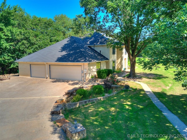 8934 S 41st W Ave, Tulsa, OK 74132 - view of front facade featuring brick siding, a front yard, concrete driveway, a shingled roof, and a garage