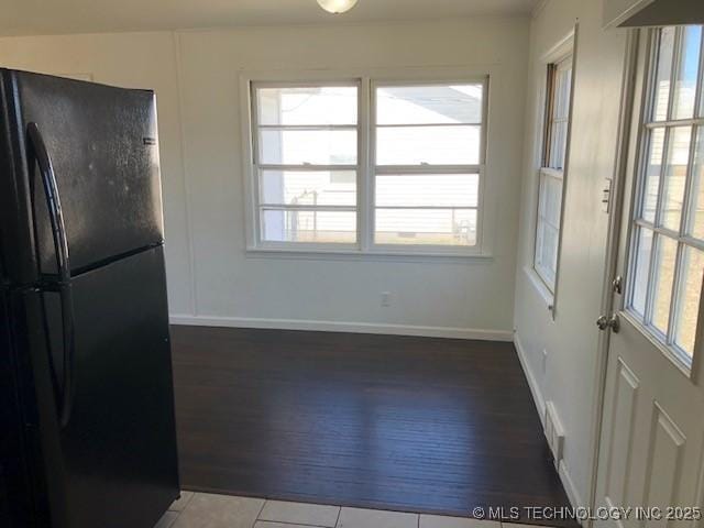 interior space featuring baseboards and tile patterned floors