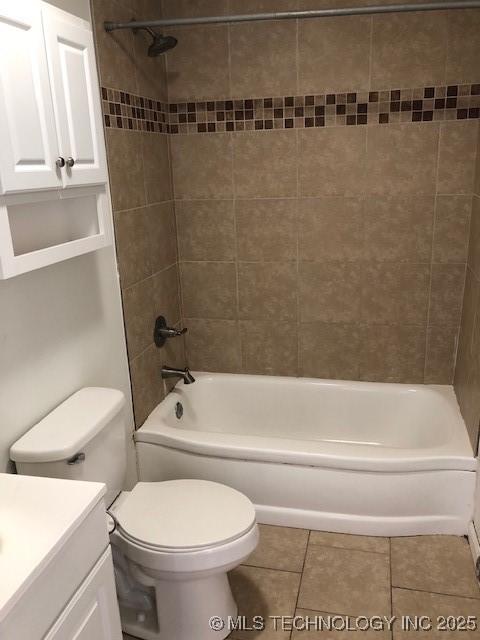 bathroom featuring toilet, tile patterned floors, bathtub / shower combination, and vanity