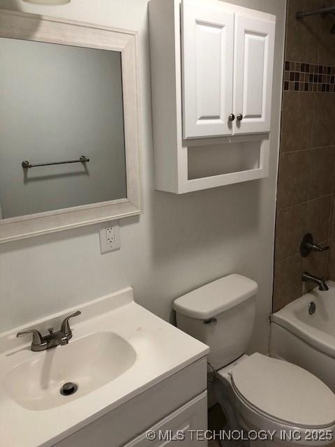 full bath featuring toilet, bathing tub / shower combination, and vanity