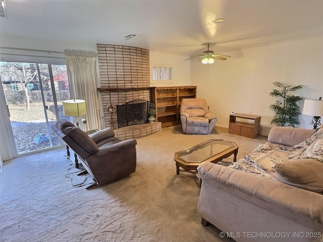 living room with a ceiling fan, a brick fireplace, visible vents, and carpet flooring