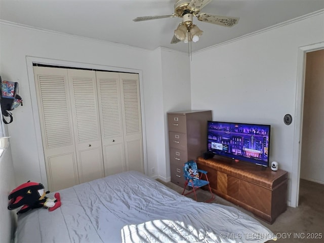 bedroom with a closet, carpet, a ceiling fan, and crown molding