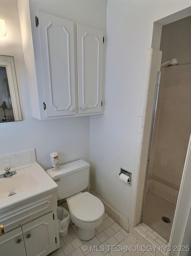 full bath with vanity, a stall shower, tile patterned flooring, and toilet