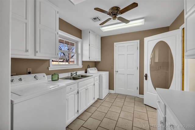 laundry area with a sink, visible vents, a ceiling fan, cabinet space, and washing machine and clothes dryer