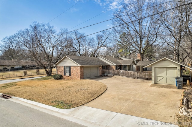 single story home featuring concrete driveway, brick siding, fence, and an attached garage