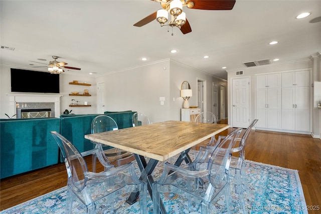 dining area featuring a fireplace, visible vents, wood finished floors, and recessed lighting