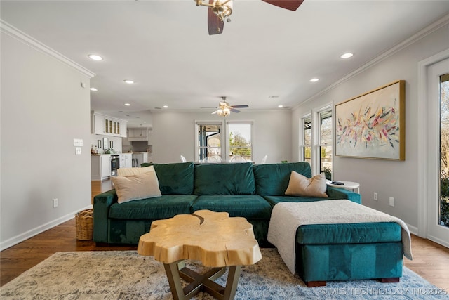 living room featuring ornamental molding, recessed lighting, wood finished floors, and baseboards