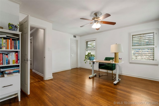 office space with crown molding, ceiling fan, baseboards, and wood finished floors