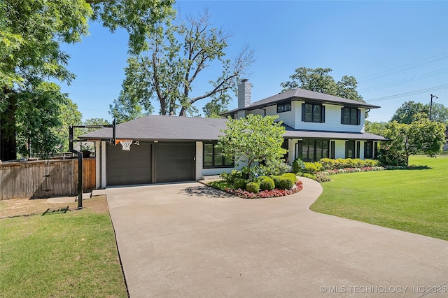 view of front of property with driveway, a garage, a chimney, fence, and a front lawn