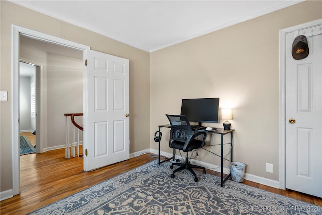 office featuring baseboards, ornamental molding, and wood finished floors