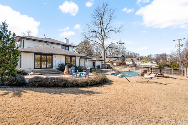 view of swimming pool with a patio, a yard, a fenced backyard, and a fenced in pool