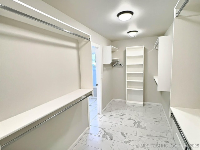 spacious closet with marble finish floor