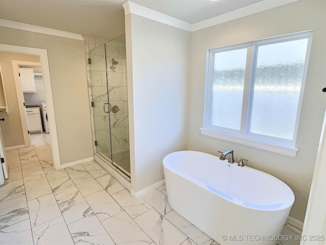 bathroom featuring marble finish floor, crown molding, a shower stall, a freestanding tub, and baseboards