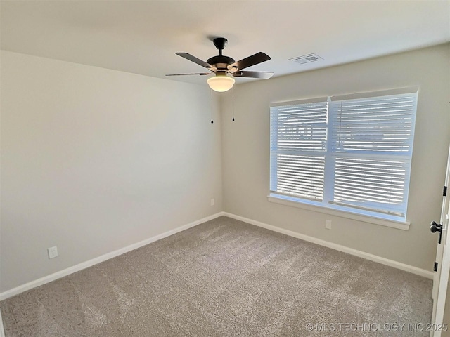 unfurnished room with ceiling fan, carpet flooring, visible vents, and baseboards