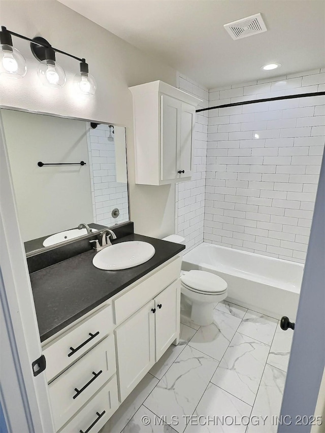 bathroom with bathtub / shower combination, toilet, vanity, visible vents, and marble finish floor