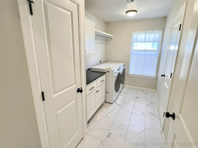 clothes washing area with visible vents, baseboards, marble finish floor, cabinet space, and washer and clothes dryer