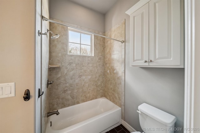 full bathroom featuring bathtub / shower combination, toilet, and baseboards