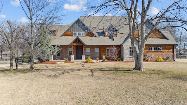 view of front of home with fence and a front lawn