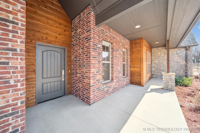 property entrance featuring brick siding