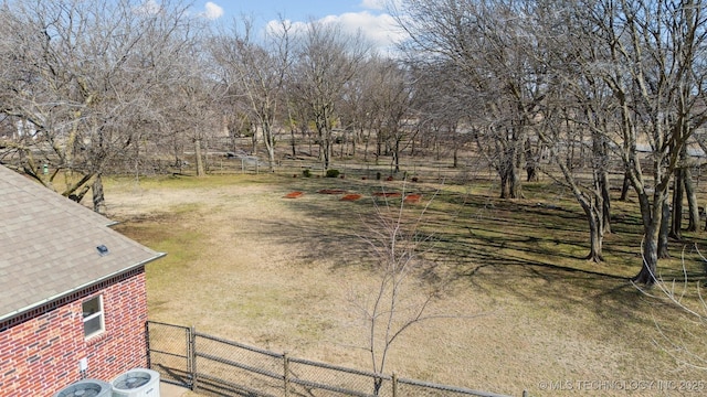 view of yard with fence and central air condition unit