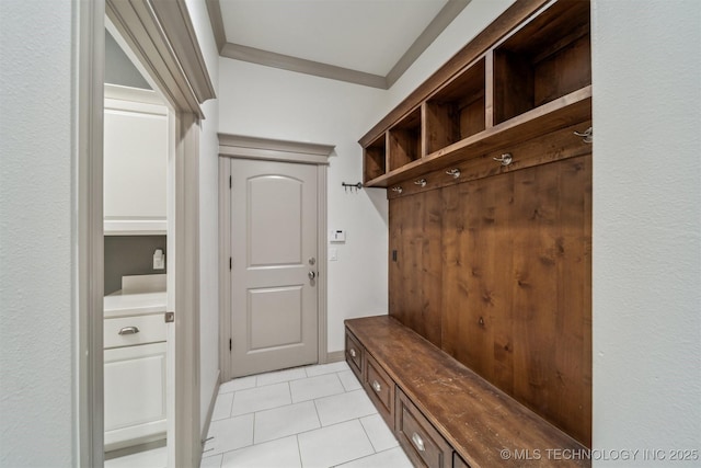 mudroom with ornamental molding and light tile patterned flooring