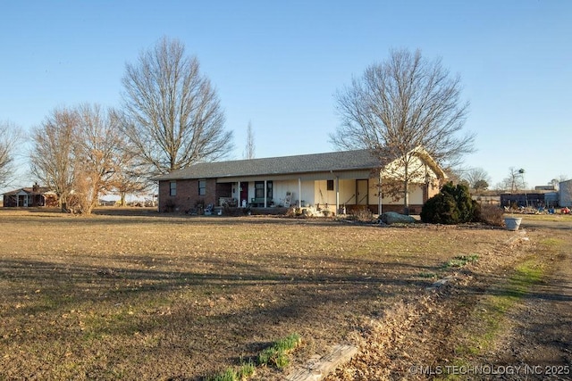 view of front of house with covered porch and a front yard