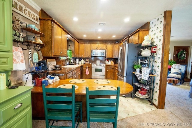 kitchen featuring open shelves, stainless steel appliances, light countertops, light colored carpet, and a sink