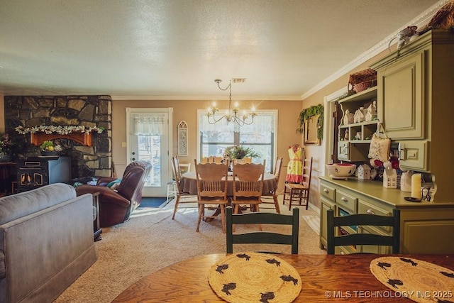 dining area featuring an inviting chandelier, ornamental molding, and a textured ceiling