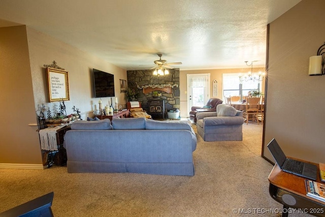 living room featuring a textured ceiling, carpet flooring, and ceiling fan with notable chandelier