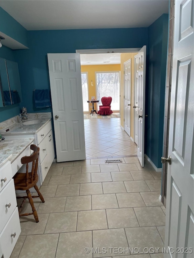 bathroom featuring vanity, baseboards, and tile patterned floors