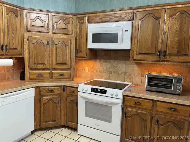 kitchen with white appliances, brown cabinetry, and a toaster