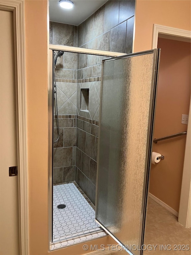 full bath with a stall shower and tile patterned floors