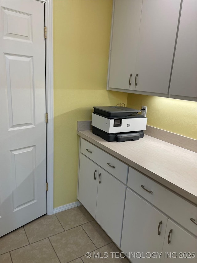 kitchen featuring white cabinets, light countertops, and light tile patterned floors