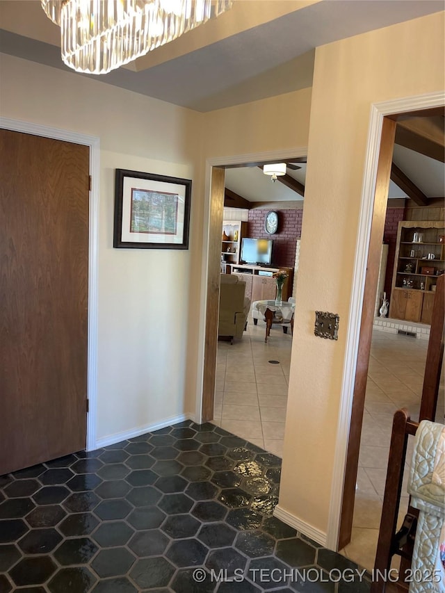 hallway with lofted ceiling with beams and tile patterned flooring