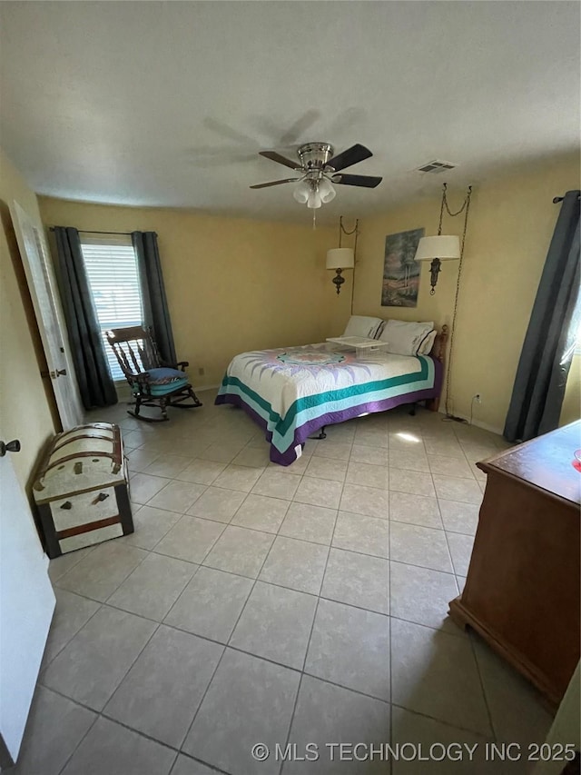 bedroom featuring ceiling fan, tile patterned flooring, and visible vents