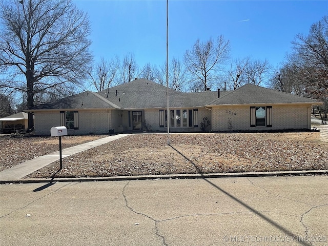 ranch-style house with brick siding