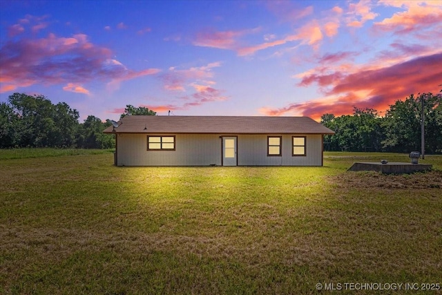 rear view of property with a yard