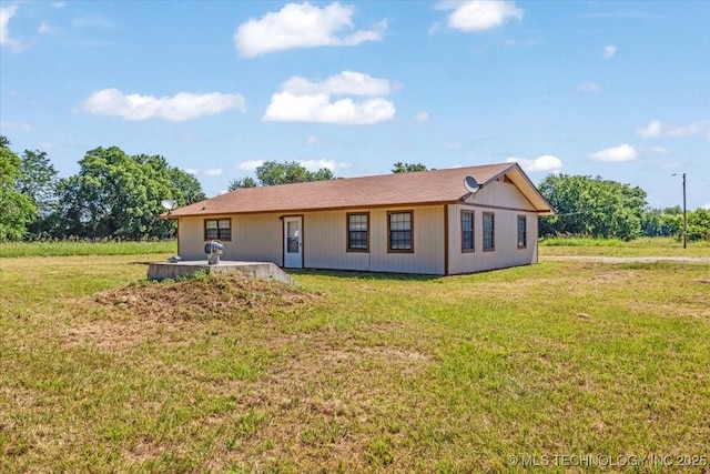 rear view of house with a lawn