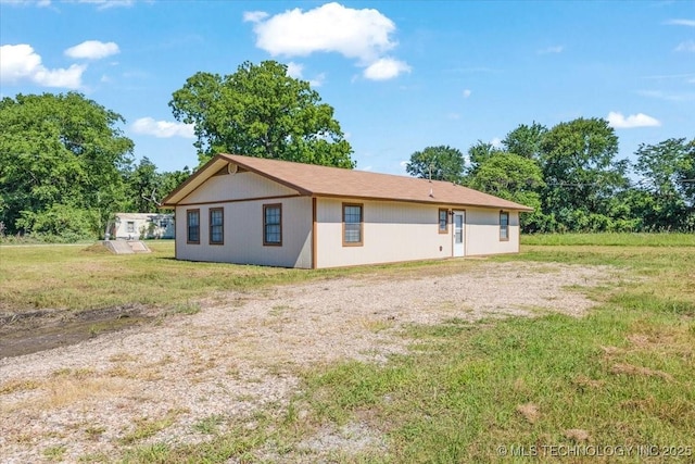 back of house with a yard