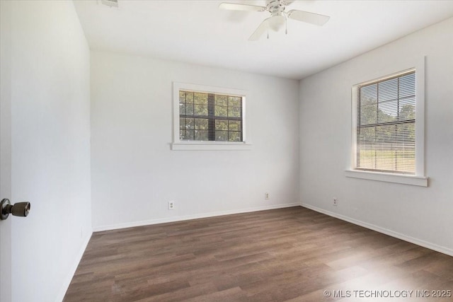 spare room featuring a ceiling fan, baseboards, and wood finished floors